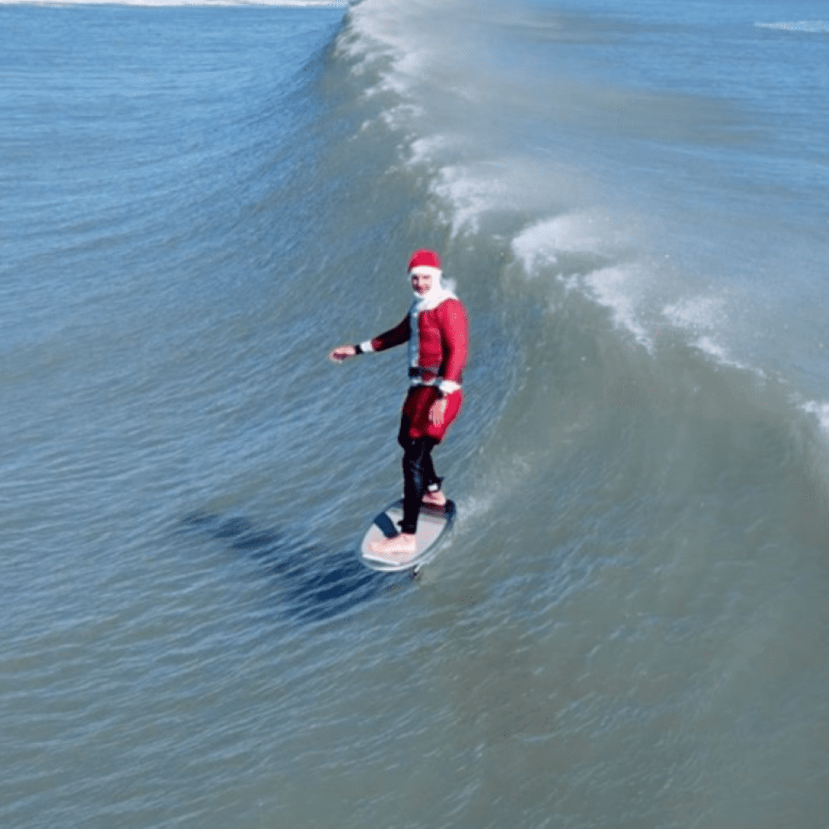 A Huge Crowd of Surfing Santas Paddled Out in Florida on Christmas Eve -  Surfer